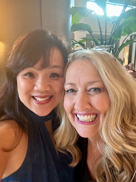 Friends sharing a joyful moment at a mortgage conference