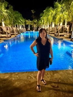 A President’s Club guest beside the resort pool at night