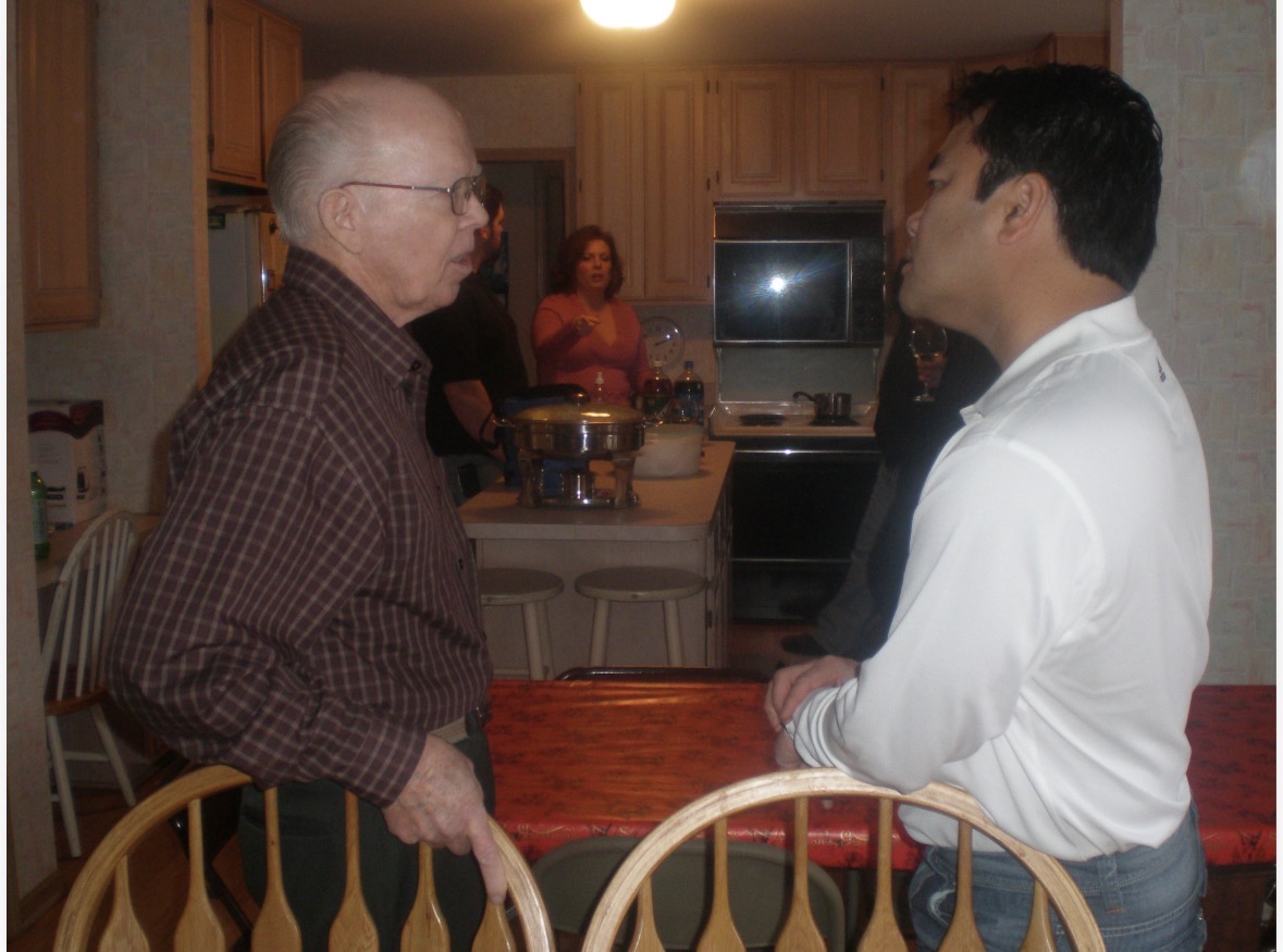 Cathy’s father and husband sharing a conversation at a family gathering